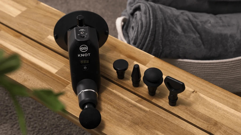 Dr. Knot Wall-Mounted Massage Gun product on bench
